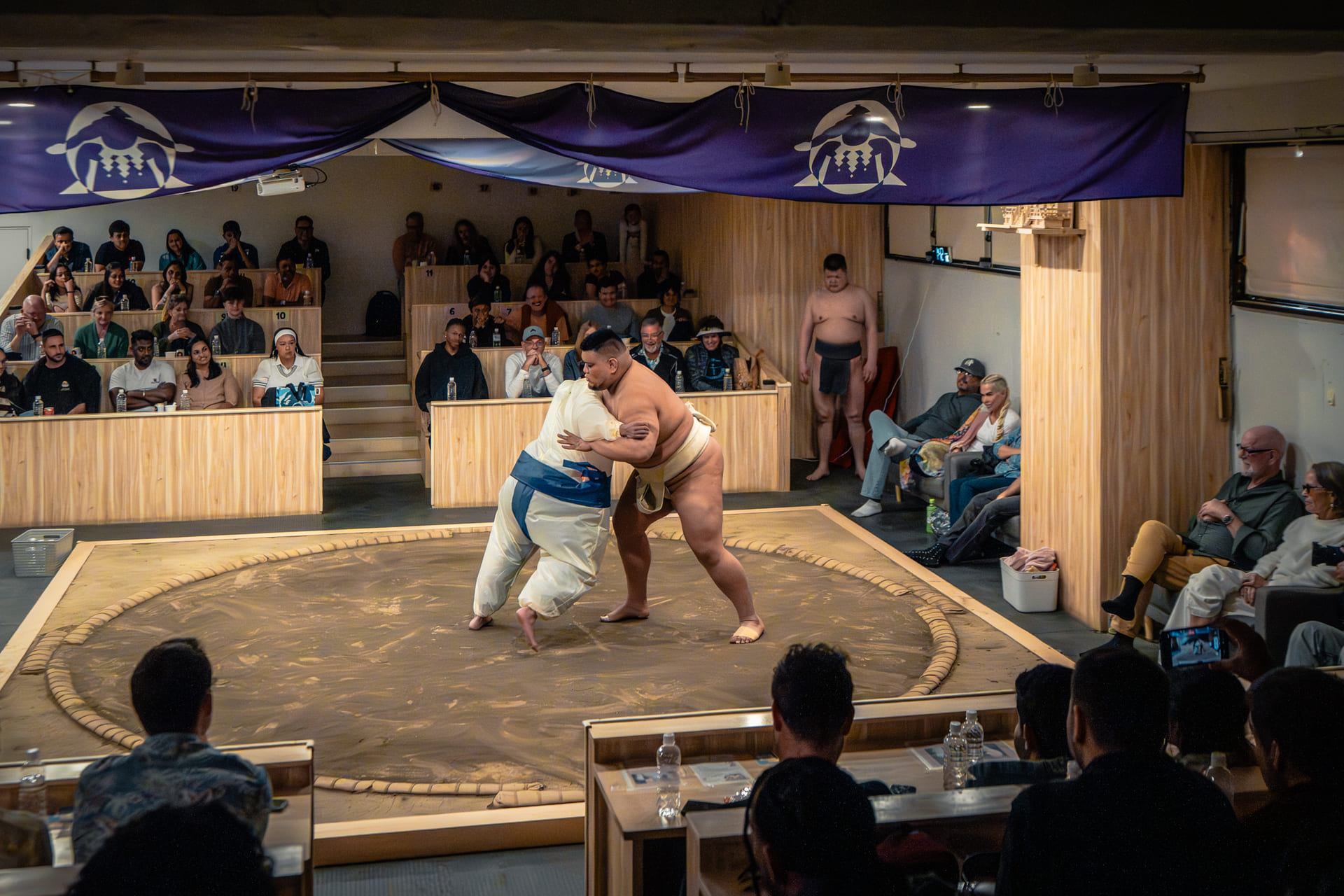 Guest challenges sumo wrestler in the ring